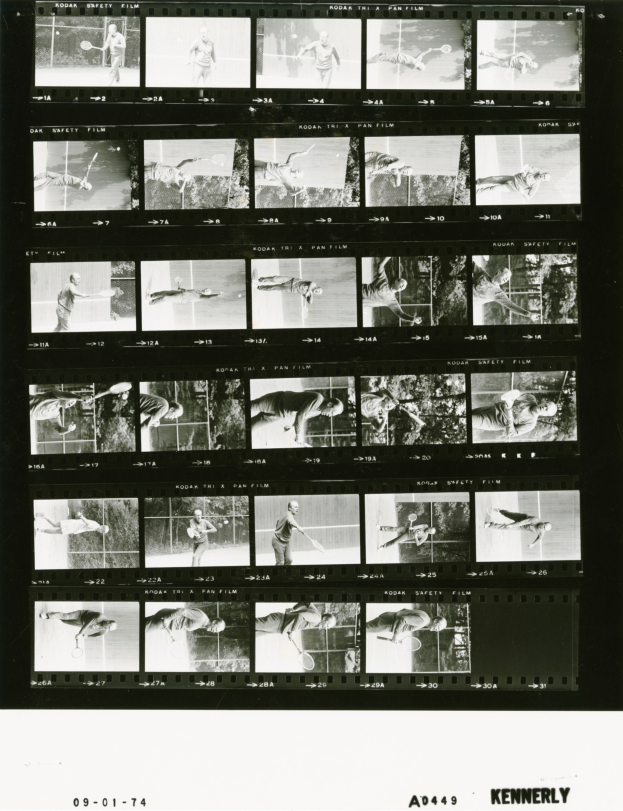 Schwarzes und weißes Foto eines konzentrierten Tennisspielers in einem weißen Hemd und Shorts, der einen Schläger hält, mit einem Filmstreifen im Hintergrund.